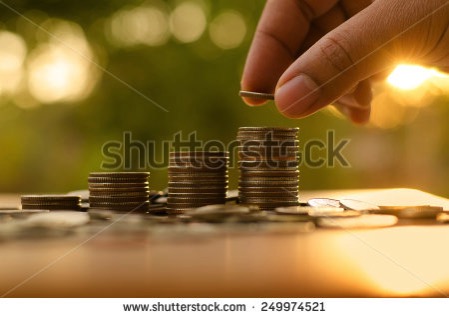 Stock photo saving money concept male hand putting money coin stack growing business 249974521 1
